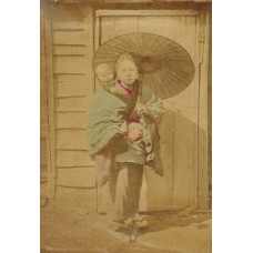 Japanese woman with child and umbrella, in front of wooden door.